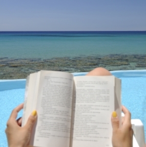 girl on beach reading book